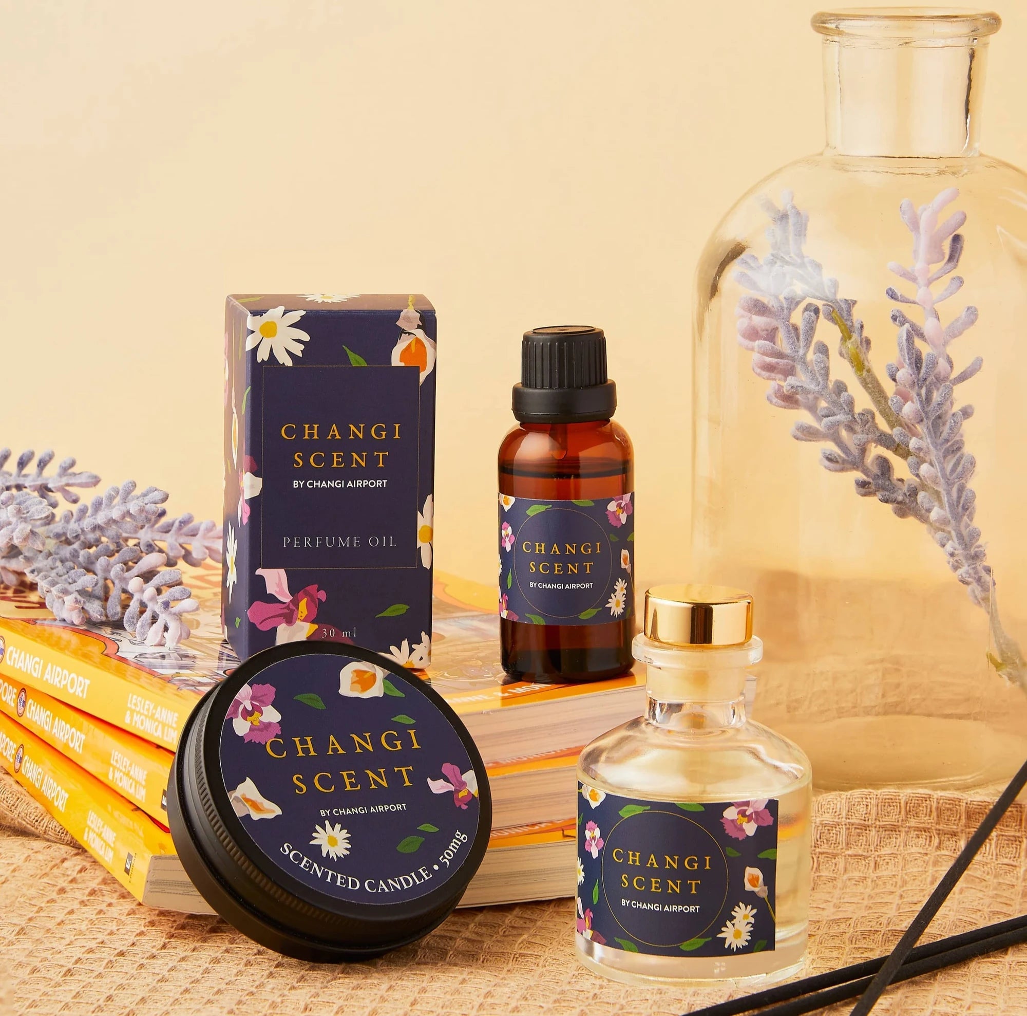 Changi Scent fragrance products arranged with orchid flowers